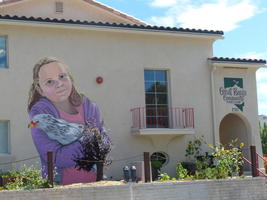 Huge wall painting of girl holding a chicken