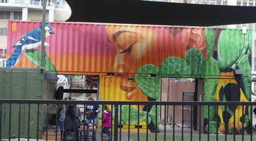 Blue bird on cactus, woman with eyes closed - painted on corrugated metal