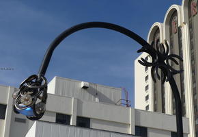 Modernistic lamp post with blue glass covering on bulb