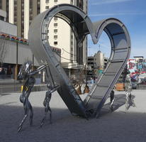 Metal heart supported by woman, man, and children