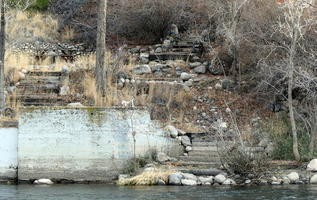 Badly weathered stone staircase at river bank