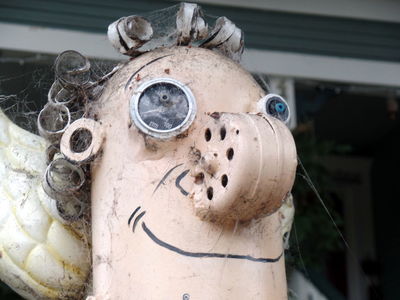 Closeup of sculptured angel with pressure gauge for eye.