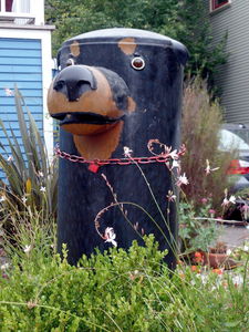 Head of black dog with brown eye spots and nose.