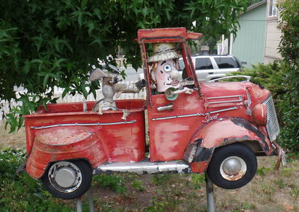 Man in pickup truck w. dog in back