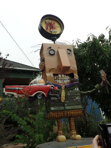 Used car salesman with “OK used cars” sign on head