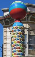 Column with “clasped hands” in relief and multi-colored ball on top