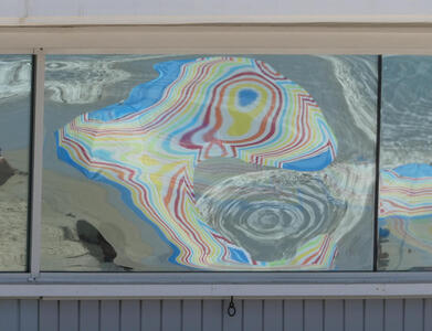 Warped mirror image of beach umbrella