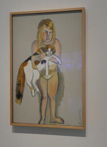Girl holding a large calico cat