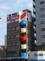 Giant cups on side of building that houses a tableware company