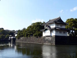Building and trees in background, moat in foreground