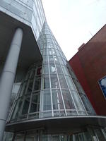 conical glass attachment to building