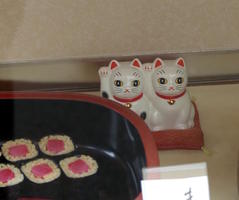 cat figurines in restaurant display case