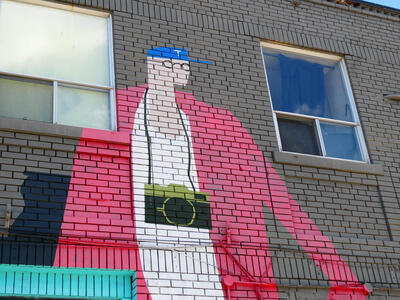 man with glasses and camera