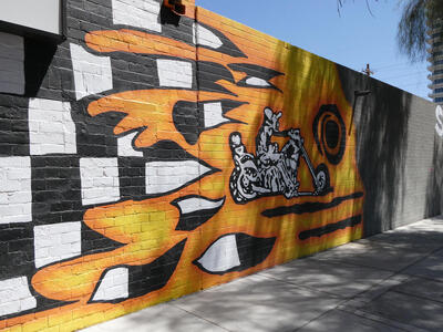 man on motorcycle flames in background