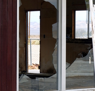 Empty room through broken windows