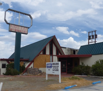 Abandoned restaurant; large sign only says “Kids Eat Free”