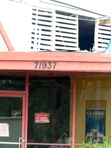 Front door of restaurant with “Sorry we're closed” sign.