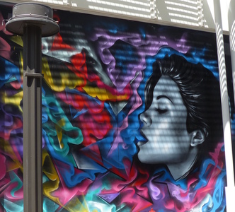 Wall art; woman kissing multi-hued man