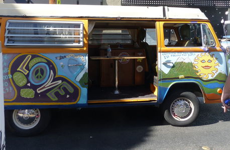 VW van with 1960s slogans painted on it.