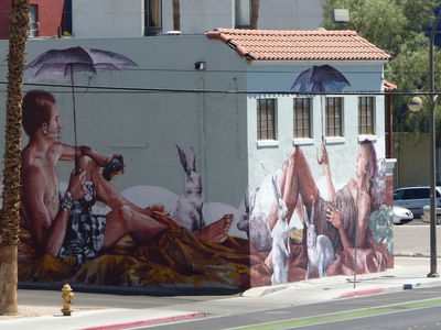 Man and woman at beach on right-angled corners of a building