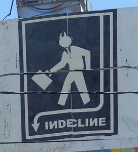 “Indecline” (silhouette of devil in business suit carrrying briefcase)