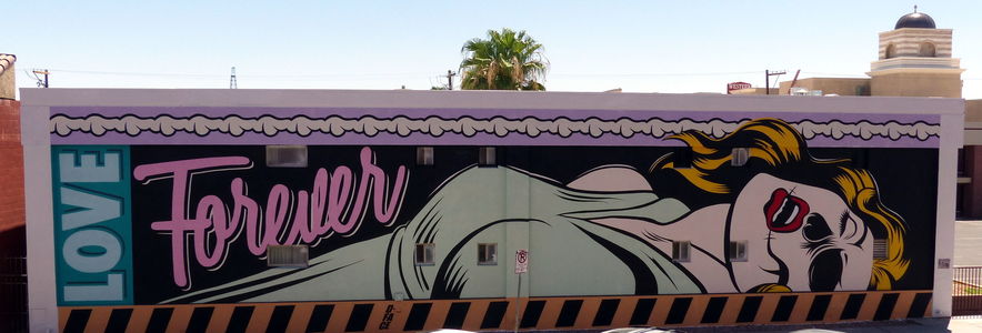 Recently deceased woman on back with caption “Love Forever”; wall mural on long building