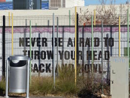 Sign reading “Never be afraid to throw your head back and howl.”