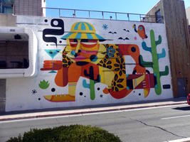 Abstract wall art of man with martini and suitcase runing through desert.