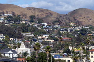 Closeup of houses on hillside, one with a square fenced area