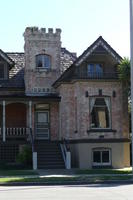 Brick housewith second story window that looks like a castle tower