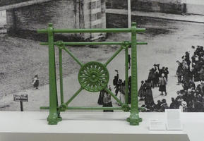 Sculpture of green wheel in rectangular frame