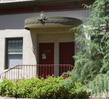 House with semi-circular overhang decorated with scrollwork